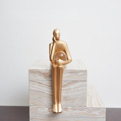 Golden Geometric Sitting Statue